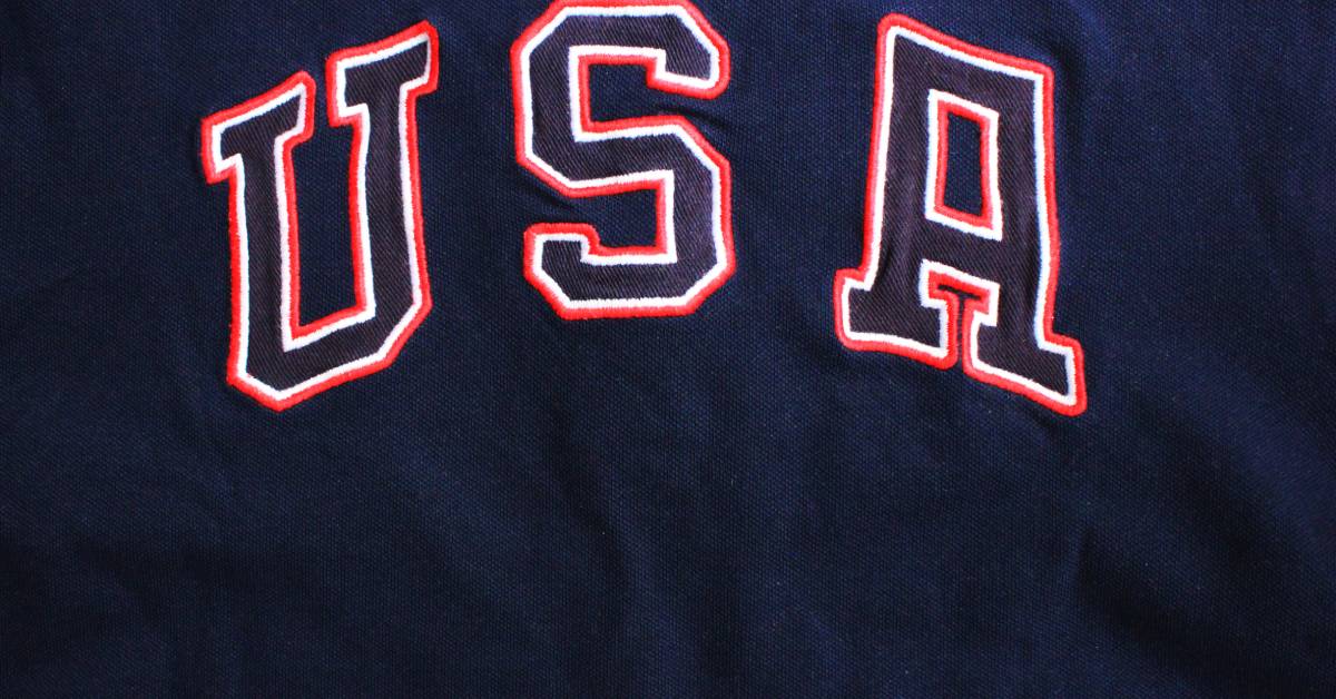 A garment made of dark blue fabric. Embroidered on it is a red, white, and blue logo that reads "USA."